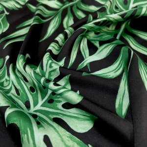 Атлас с торговым названием Армани, на черном фоне крупные зеленый листья. Тактильно атлас очень приятный, мягкий т струящийся. Идеален для пошива рубашки или платья.